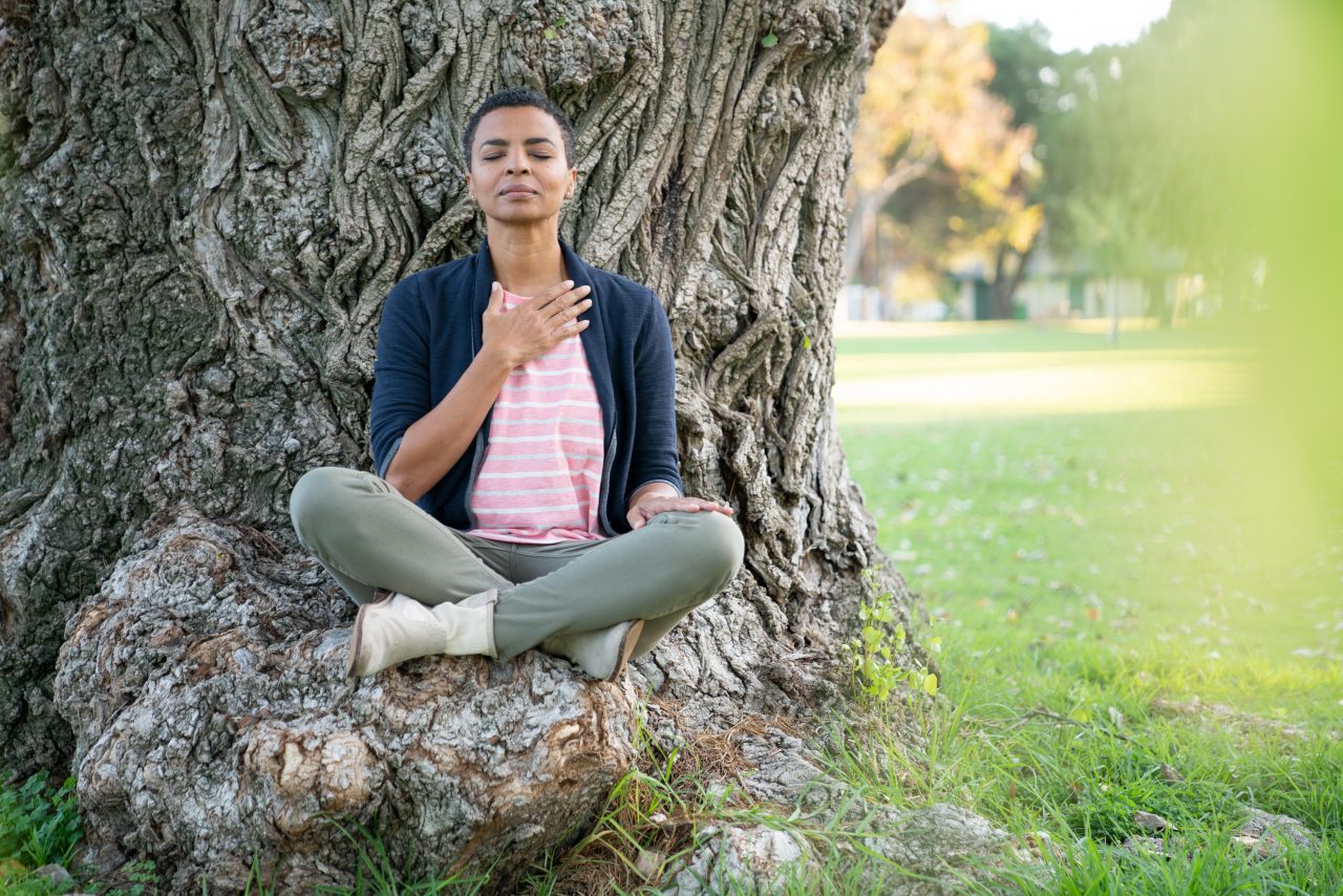 Woman meditating in the park