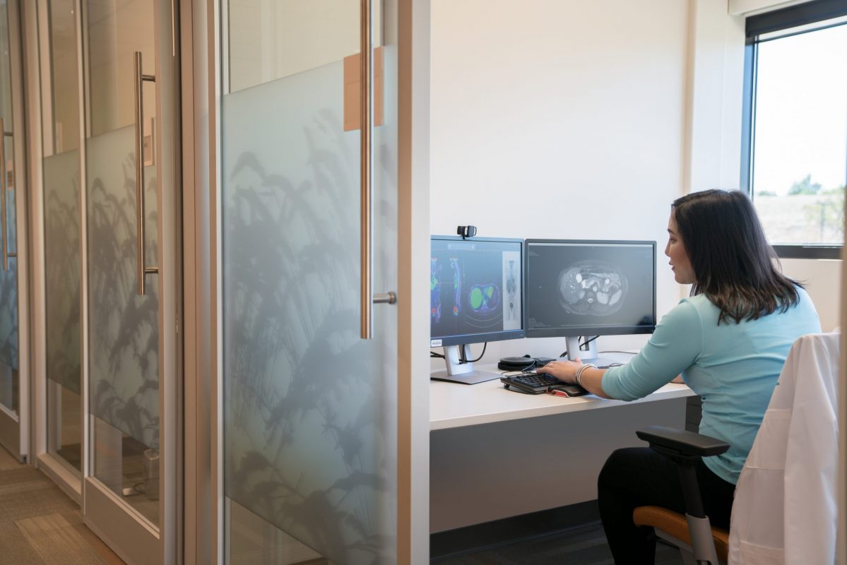 Doctor reviewing scans on a computer